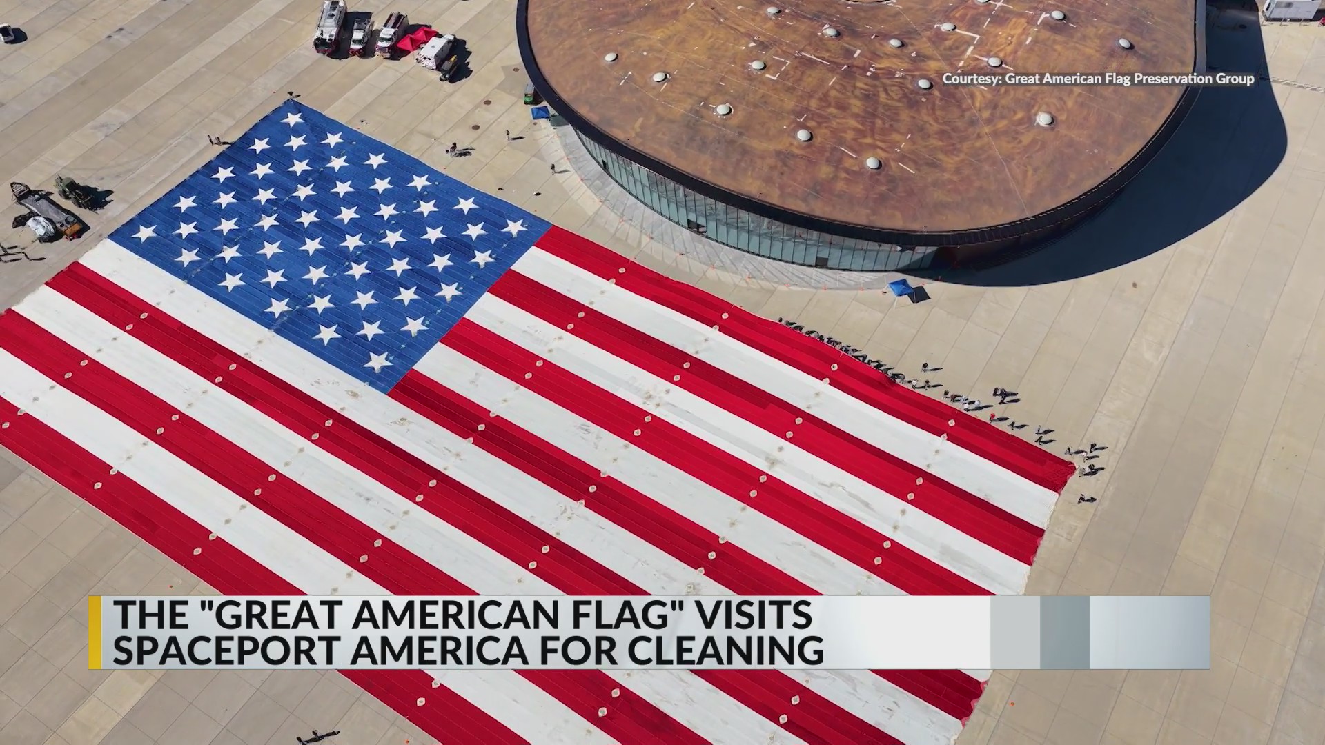 Volunteers help clean giant American flag at Spaceport America in New ...